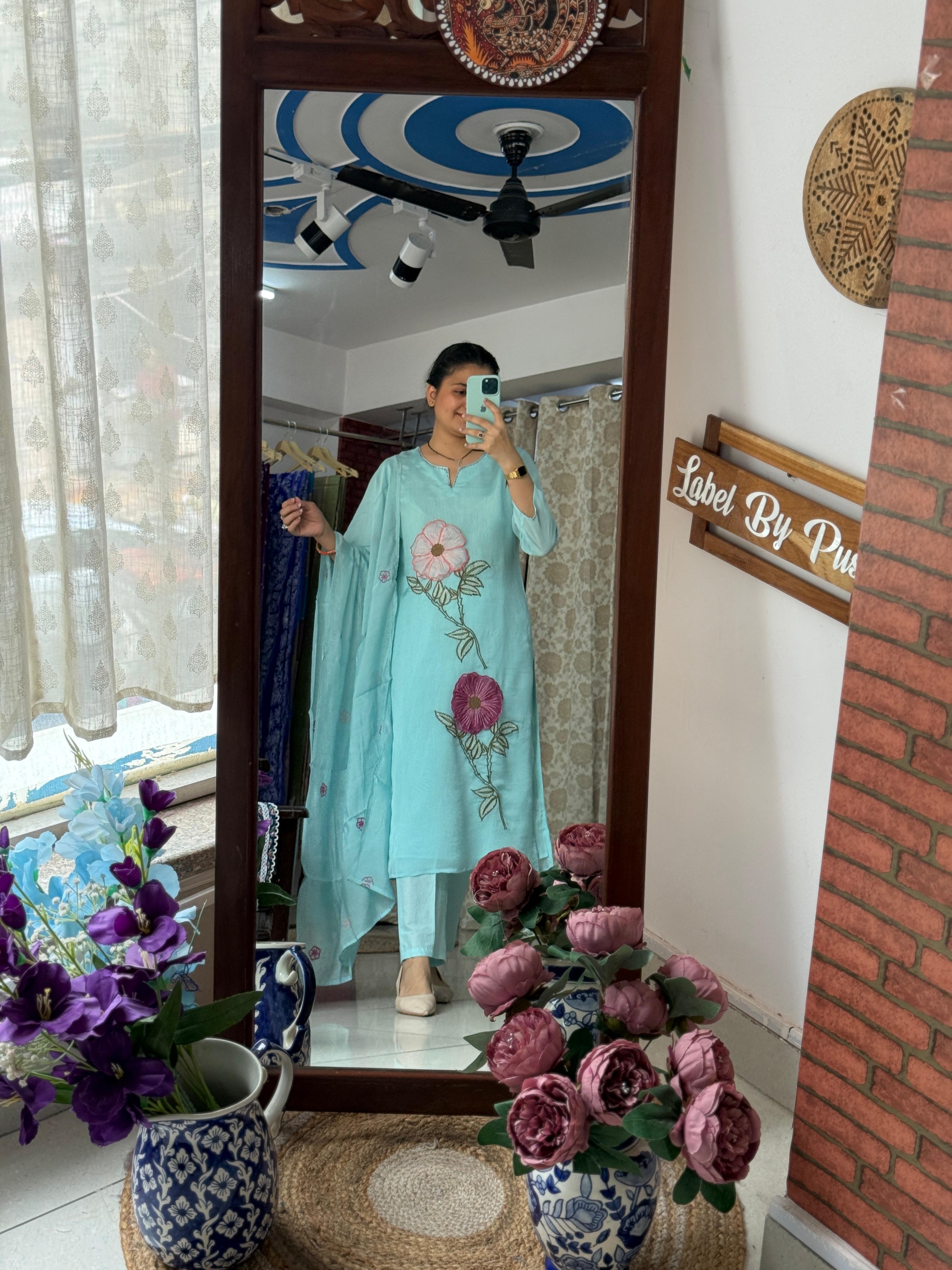 Woman wearing sky blue 3D embroidered suit set with floral embroidery, matching pants and dupatta by Label by Pushp
