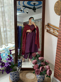 Woman wearing a wine purple handwork cotton suit set with matching pants and woven dupatta by Label by Pushp