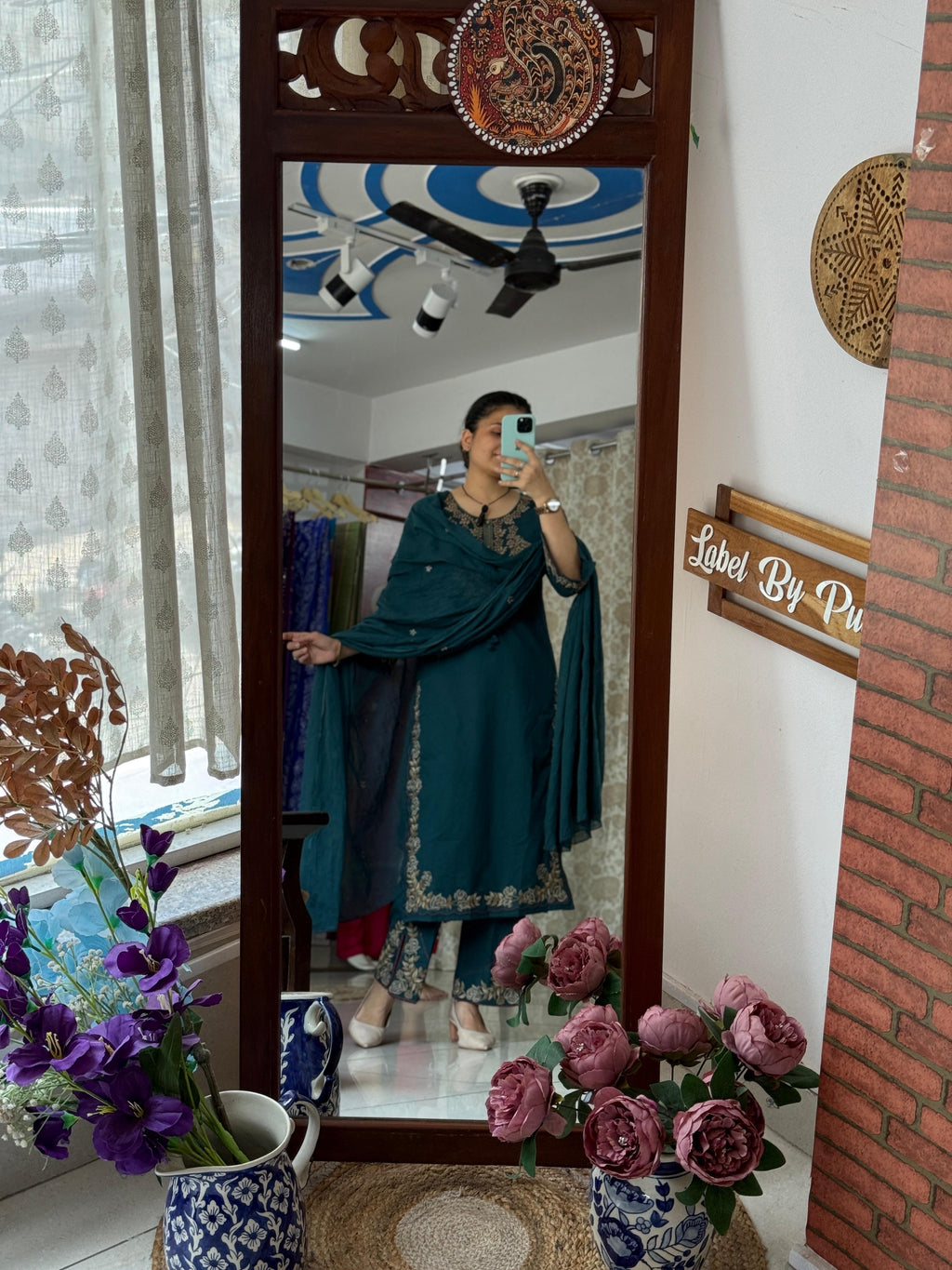 Woman wearing a teal designer cotton suit set with embroidered neckline, matching straight pants, and coordinated cotton dupatta by Label by Pushp