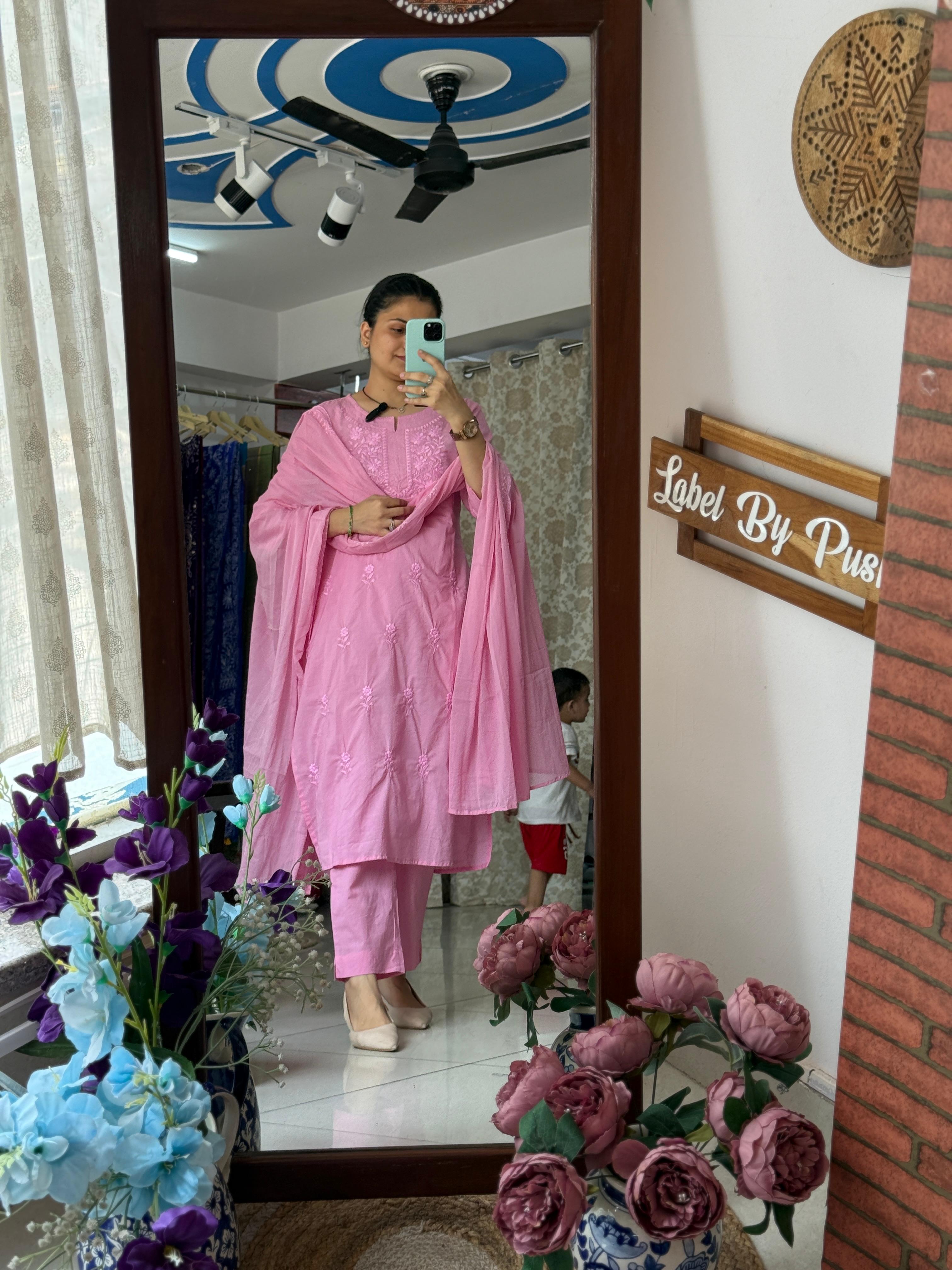 Woman wearing a baby pink embroidered cotton suit set with delicate floral embroidery, matching straight pants, and a cotton dupatta by Label by Pushp